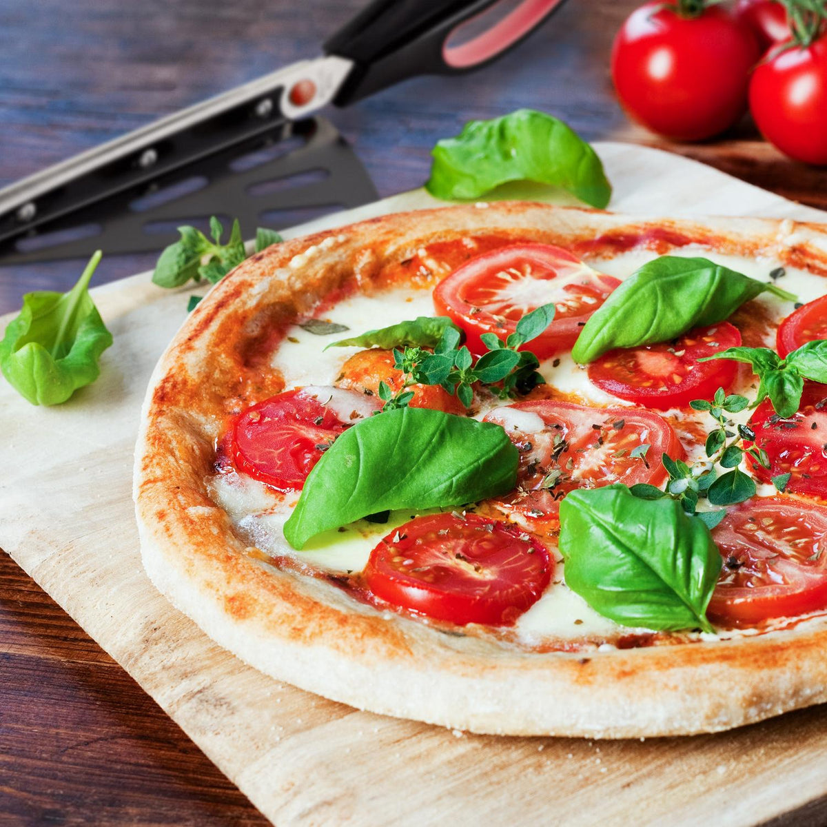 Black and red pizza cutter with lifting device
