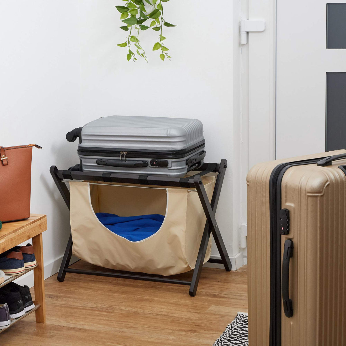 Black suitcase rack with laundry bag