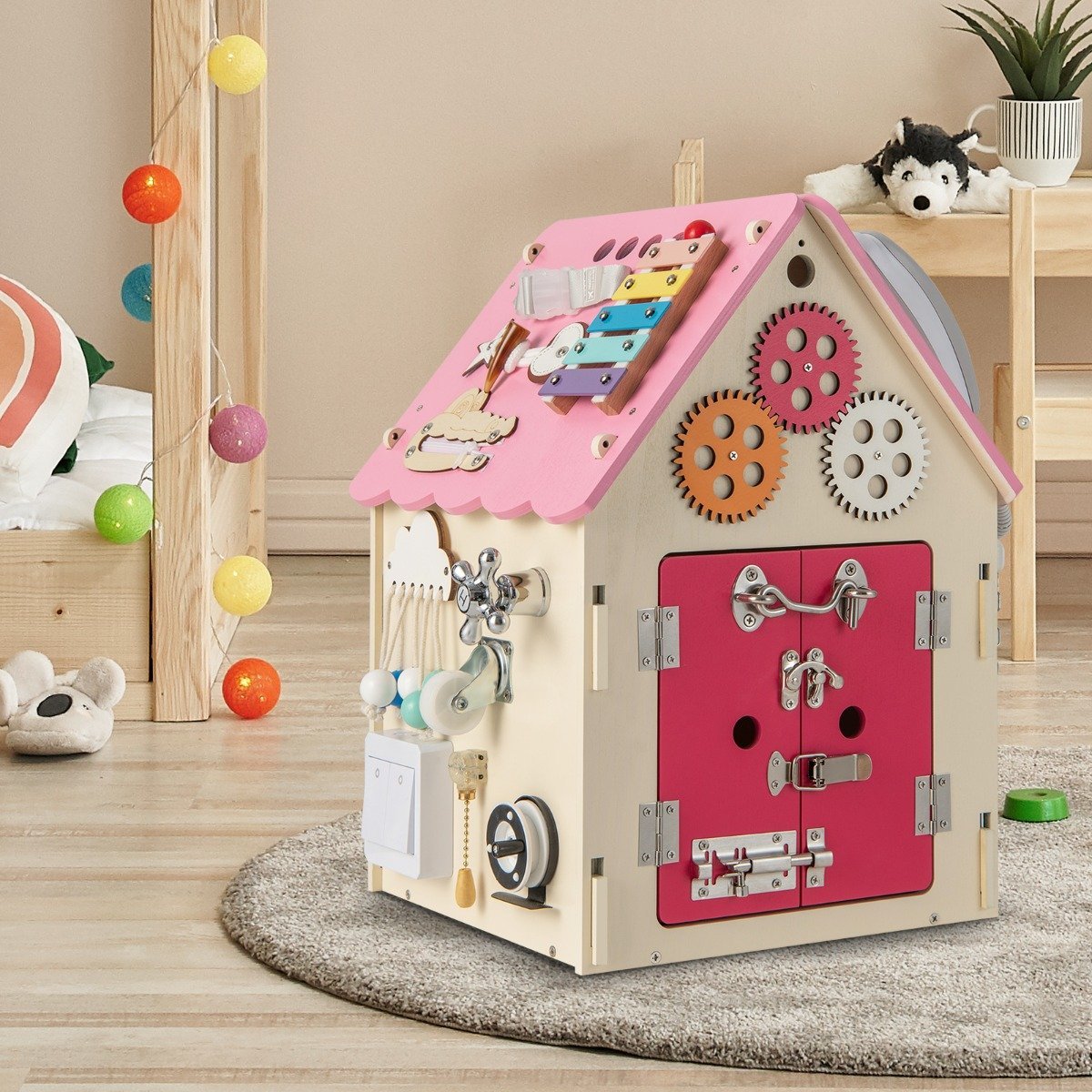 Children's wooden playhouse with sensory games and storage space for children aged 3 and over. Pink