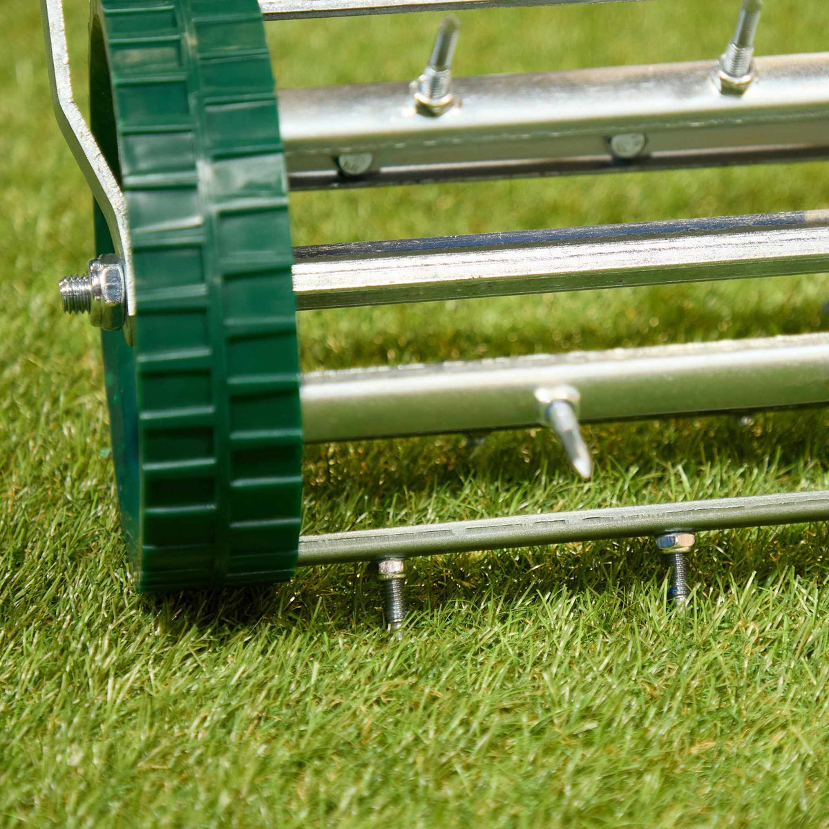 Rolling lawn aerator with handle